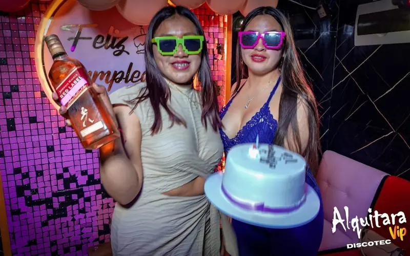 Dos amigas celebrando un cumpleaños con torta en Alquitara VIP